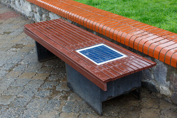 Obraz na płótnie Canvas A bench with a built-in solar panel for charging phones.
