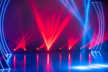 Professional lighting equipment lies on the floor of the stage in the concert hall.
