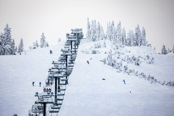 Fototapeta na wymiar Chairlifts in the snow for the ski season in USA.