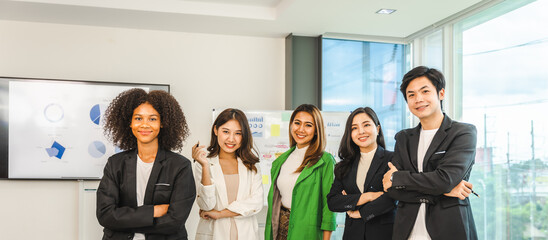 Fototapeta premium Multiracial business team on a meeting in a modern bright office, Diverse colleagues working on project together, sitting at table in boardroom.