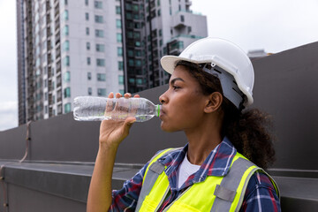 Industrial engineer or Worker drinking water in factory site.	
