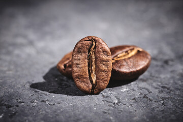 Roasted coffee beans on gray background