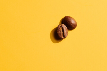 Roasted coffee beans on yellow background