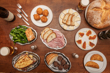 Set of modest Galician food recipes, tetilla cheese with quince, cod dumplings, padron peppers, croquettes and village bread