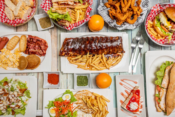 American style fast food recipes, barbecue ribs, pancakes with bacon and scrambled eggs, hamburgers, combination plate with chicken, salad and fries, cheesecake with syrup
