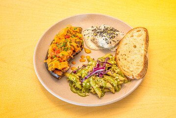 Delicious vegan food recipe, pasta with green sauce, baked eggplant and slice of bread