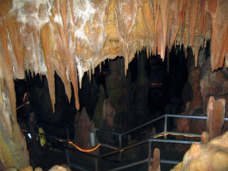 Ancient karst cave with stalactites and stalagmites, Petralona cave Greece Cenote ceiling and limestone decoration.