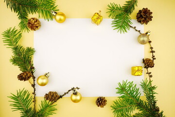 Fototapeta na wymiar Christmas frame with fir branches and cones. New Year composition on white background with golden balls. Top view, copy space, flat lay.