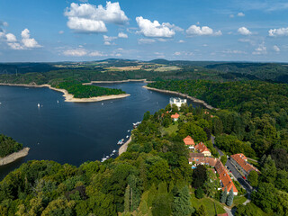 Fototapeta na wymiar Czechia, Orlik Castle and Vltava River Aerial View. Czech Republic. Beautiful Summer Green Landscape with Orlík Water Reservoir and Boats. View from Above. 