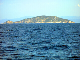 Panoramic view of the bright blue sea and the island in the distance. Beautiful landscape. Mediterranean Sea Greece.