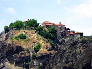 Fototapeta na wymiar Panoramic view of the Holy Trinity Monastery of Meteora in Greece high in the mountains. Unusual architecture.