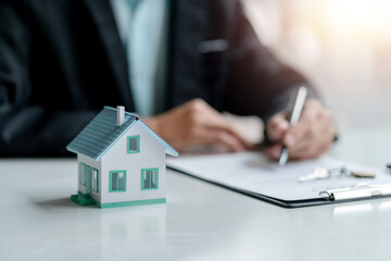 Real estate agent make contract for the sale of houses, offering house design and contract approval of a contract to buy and sell a house Offers mortgage loan and home insurance idea.