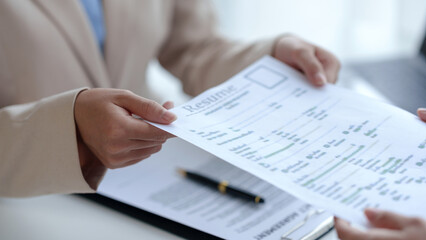 New graduate women fill out the human resources department application form review and prepare your personal document, academic history, and interview detail.