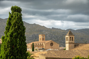 View of historical monuments of Pollença (Spain) at sunset: Church of the Mare de Déu dels Àngels and Convent of Santo Domingo