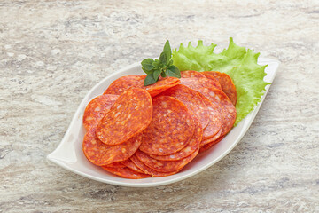 Sliced pepperoni sausage in the bowl