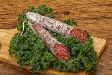 Spanish Fuet sausage with salad leaves