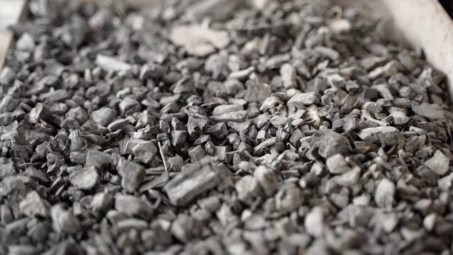 Fossil coal close-up, reserves. Smooth movement from top to bottom near hard coal in a warehouse. Raw materials for heating and electricity production. Unlimited use of the planet's resources