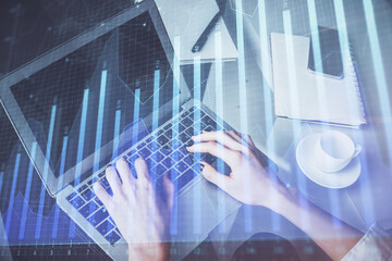 Double exposure of woman hands typing on computer and forex chart hologram drawing. Stock market invest concept.