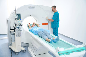 Doctor and woman patient during CT scan at medical center