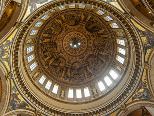 Fototapeta premium London, England, UK - July 6, 2022: St. Paul's Cathedral. Looking up inside dome. Light through windows, white statues and paintings galore.