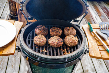 ready to eat - grilled venison burger from a charcoal grill