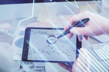 Double exposure of man's hands holding and using a phone and financial chart drawing. Market analysis concept.