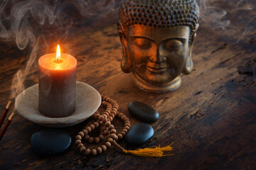 Still life with candle and Buddhist pieces