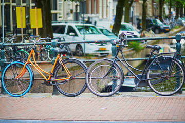 Fototapeta na wymiar Many bikes parked on the bridges and embankments in Amsterdam, the Netherlands