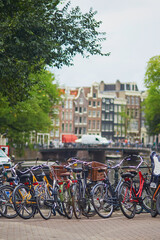 Fototapeta na wymiar Many bikes parked on the bridges and embankments in Amsterdam, the Netherlands