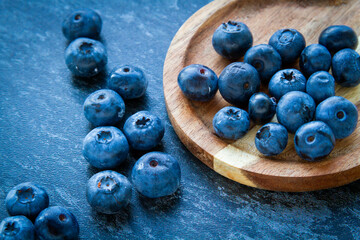 Blueberries on a wooden table. Fresh berries. Wild blueberries on a wooden stand