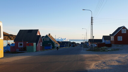 Fototapeta na wymiar Man walking down street at Ilulissat Greenland