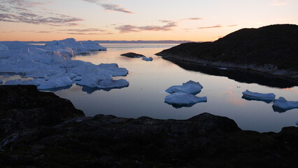 Bay of icebergs in Ilulissat Greenland in the evening