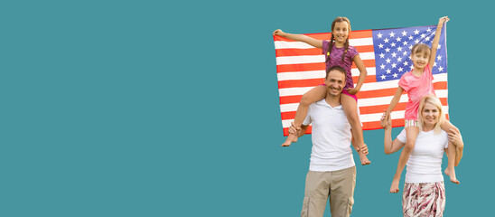 Happy young family with national flags of USA near blue wall