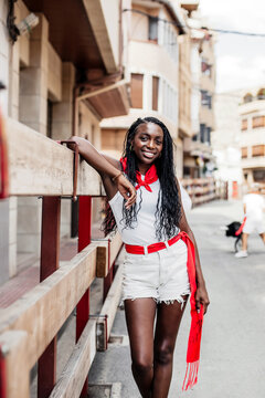 portrait of a black girl resting during the running of the bulls in the popular festivities of a town in spain. concept of fun, tolerance and diversity.