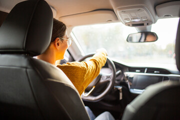 Young commuter woman driving car