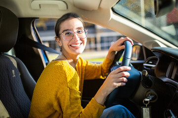 Cheerful young caucasian woman enjoying driving car