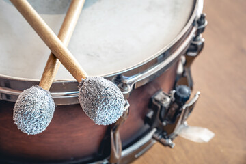 Close-up, drumsticks on a blurred background.