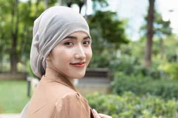 Asian woman cancer patient looking back in green rehabilitation center
