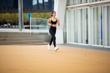 Fit young woman in sportswear on morning run