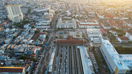 Aerial view of Jakarta Kota Train Station with Jakarta cityscape background.