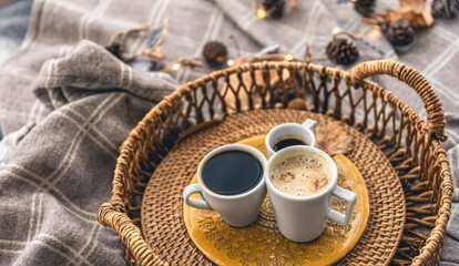 Autumn composition with cups of coffee and leaves.