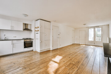 Interior of empty white kitchen with windows and wooden parquet floor