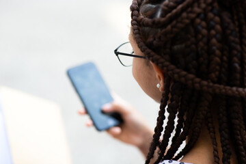 Close up of young woman looking at mobile phone screen