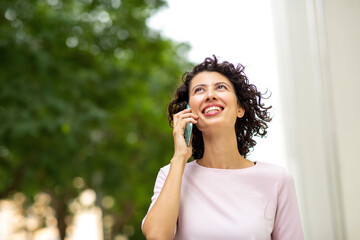Smiling woman talking on mobile phone
