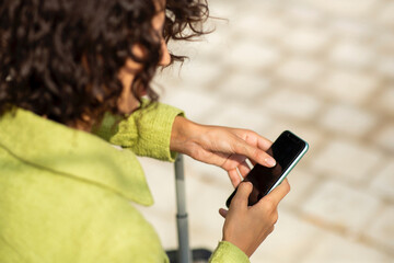 Female traveler using smart phone outdoors