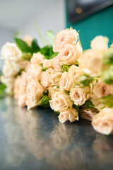 On counter in flower shop lies delicate bouquet of roses