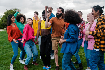 Fototapeta premium Group of young people of multi-ethnic origin dancing together outdoors