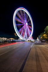 Italy, August 2022: view of the ferris wheel of Rimini with all the colored lights near the beach of the Romagna Riviera