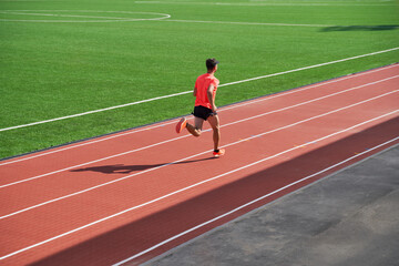 Sport man athlete is running on treadmillat the stadium