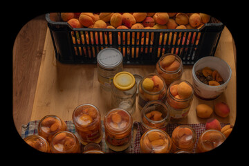 Making of apricot compote on wooden table interior summer